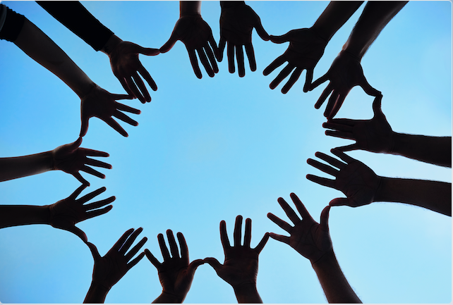 silhouetted shot of a group of hands